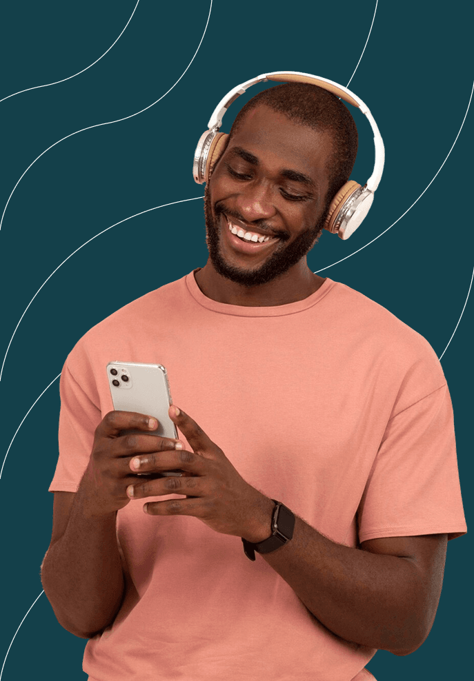 a picture of a man starring down at his phone smiling